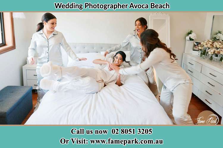 Photo of the Bride and the bridesmaids playing on bed Avoca Beach NSW 2251