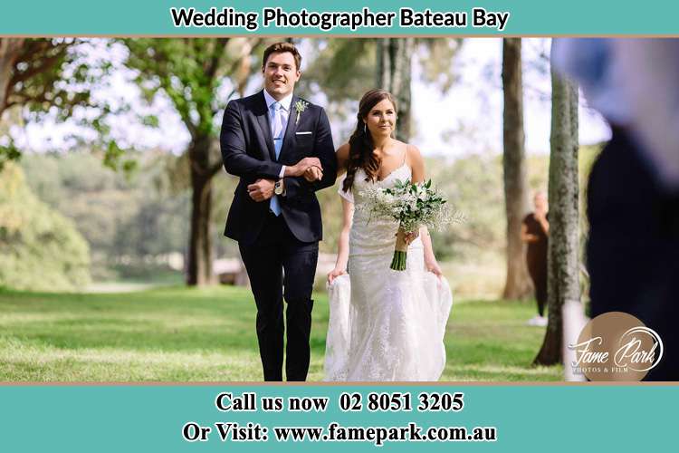 Photo of the Bride and the Groom walking in the yard Bateau Bay