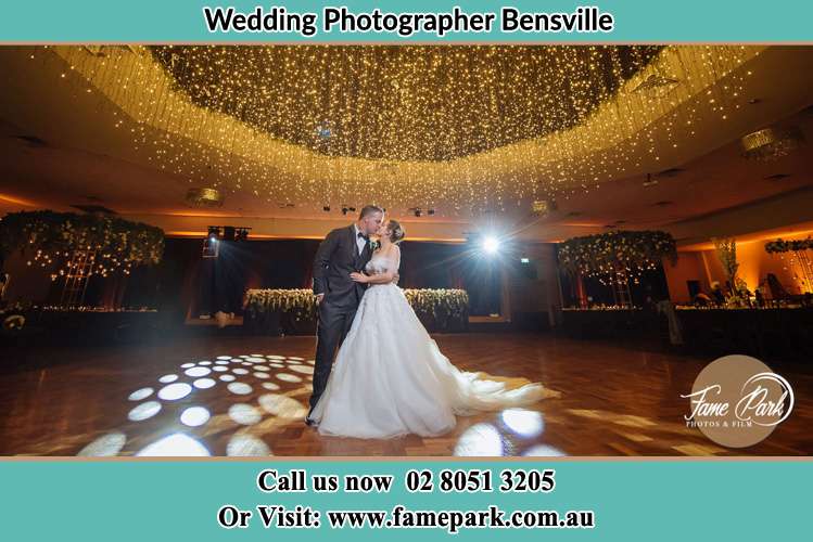 Photo of the Bride and Groom kissing at the dance floor Bensville