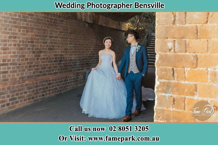 Photo of the Groom and the Bride walks while holding their hands Bensville