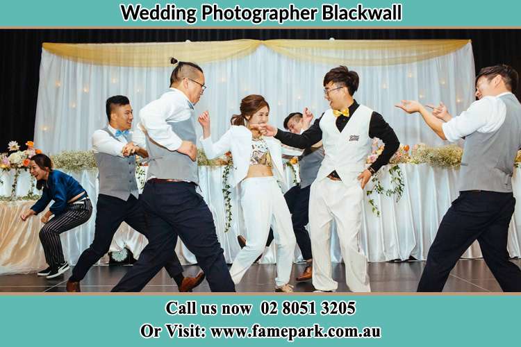 Photo of the Bride and the Groom dancing with the groomsmen at the dance floor Blackwall NSW 2256