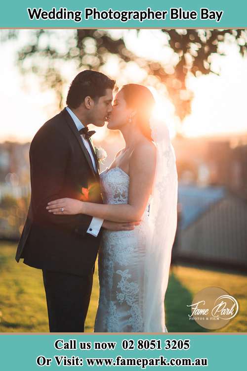 Photo of the Groom and the Bride kissing at the yard Blue Bay NSW 2261