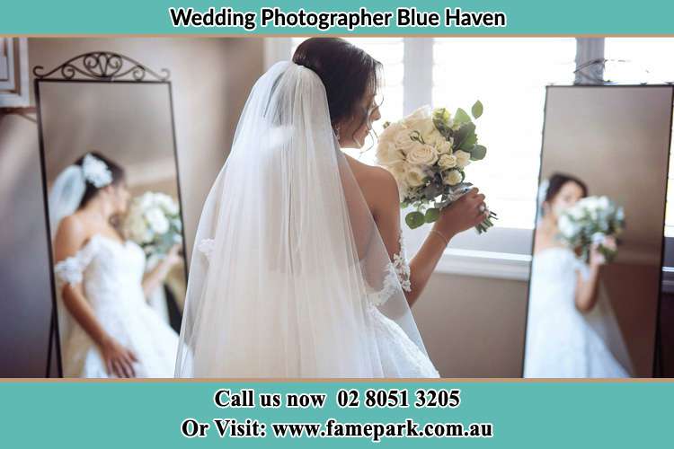 Photo of the Bride holding flower at the front of the mirrors Blue Haven NSW 2262