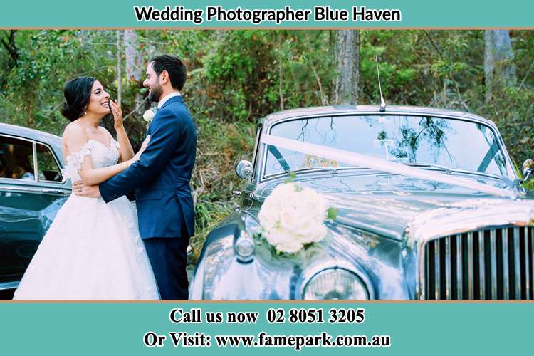 Photo of the Bride and the Groom besides the bridal car Blue Haven NSW 2262