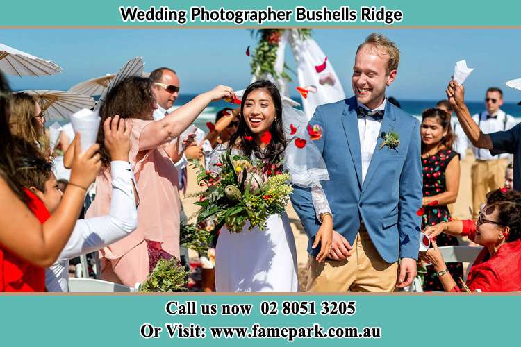 Photo of the Bride and the Groom showering flower petals by the visitors Bushells Ridge NSW 2259