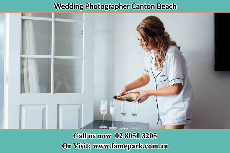 Photo of the Bride pouring wine the glasses Canton Beach NSW 2263