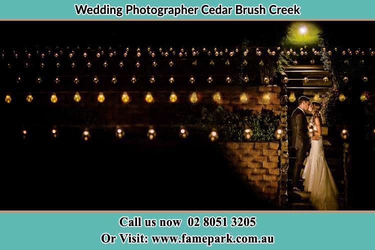 Photo of the new couple kissing at night Cedar Brush Creek