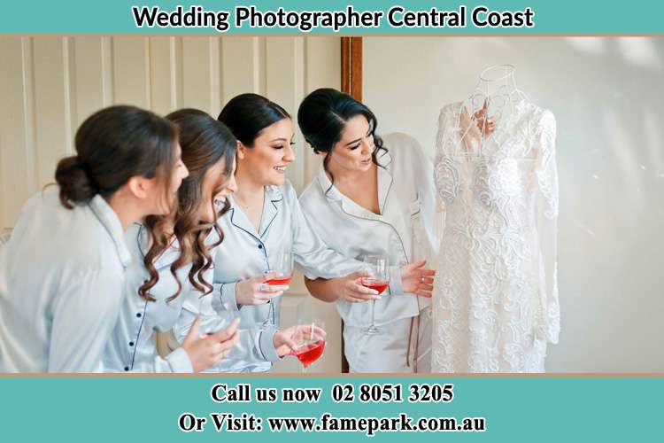 Bride looking at the gown with the girls Central Coast