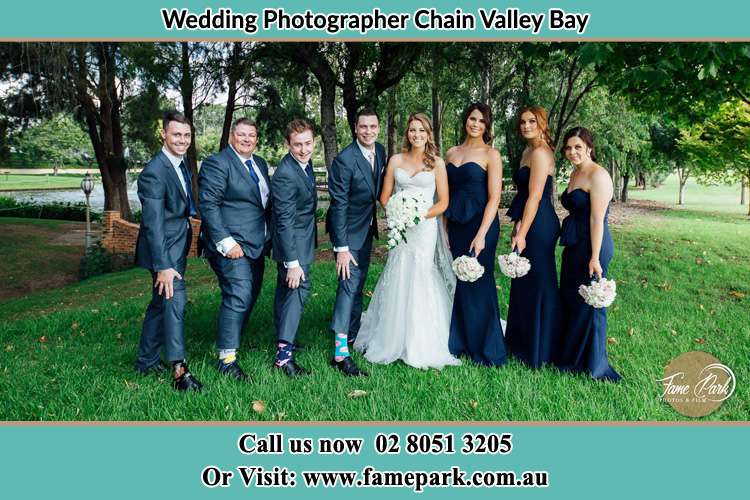 The Bride and the Groom with their entourage pose for the camera Chain Valley Bay