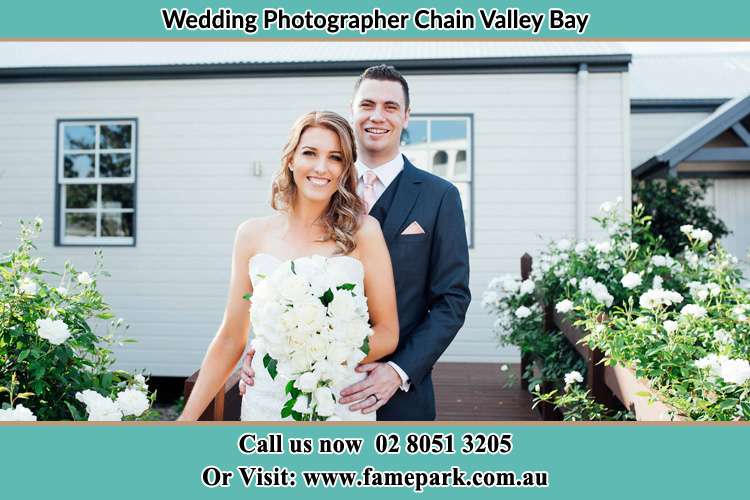 The Bride and the Groom smiling on the camera Chain Valley Bay NSW 2259