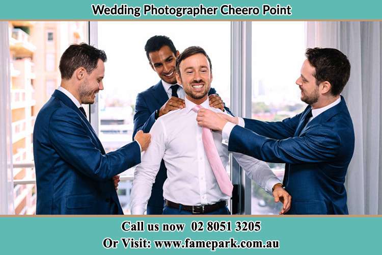 Photo of the Groom helping by the groomsmen getting ready Cheero Point NSW 2083