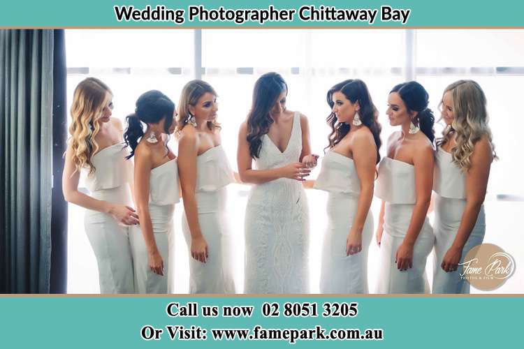 Photo of the Bride checking her ring as her bridesmaids looked on Chittaway Bay