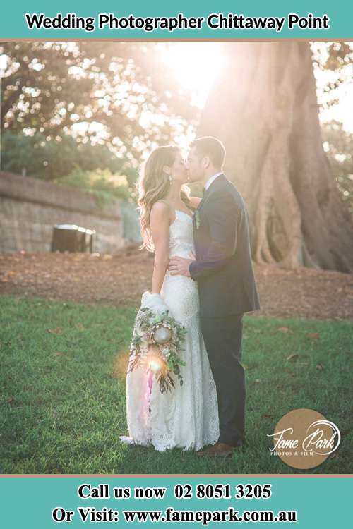 Photo of the Groom and Bride kissing near the big tree Chittaway Point