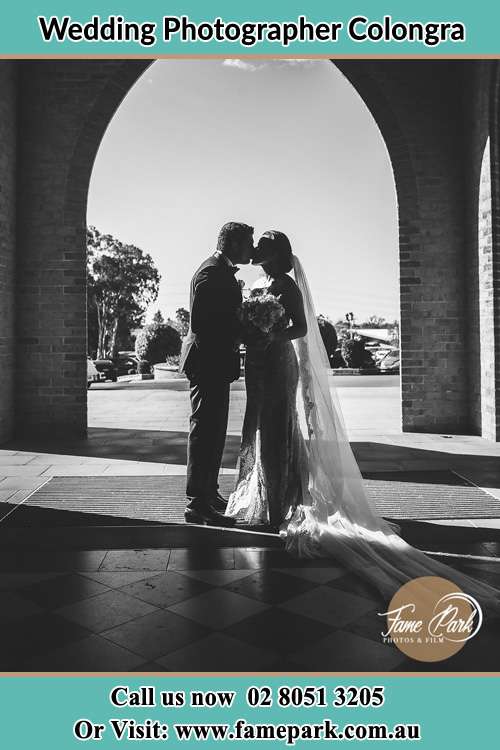 Photo of the Groom and the Bride kissing at the front of the church Copacabana NSW 2251