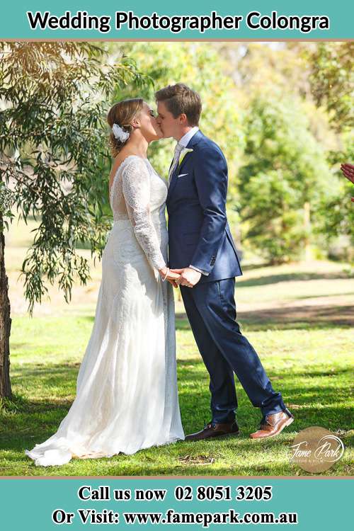 Photo of the Bride and the Groom kissing at the yard Copacabana NSW 2251