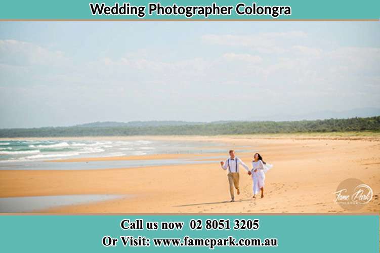 Photo of the Groom and the Bride walking near the sea front Colongra NSW 2262