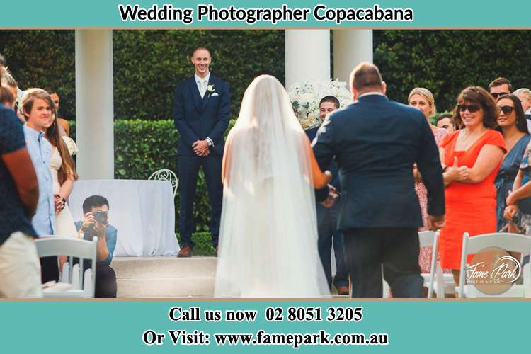 Photo of the Bride with her father walking towards to the waiting Groom Copacabana