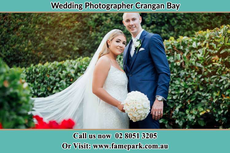 The Groom and the Bride in the garden poses for the camera Crangan Bay