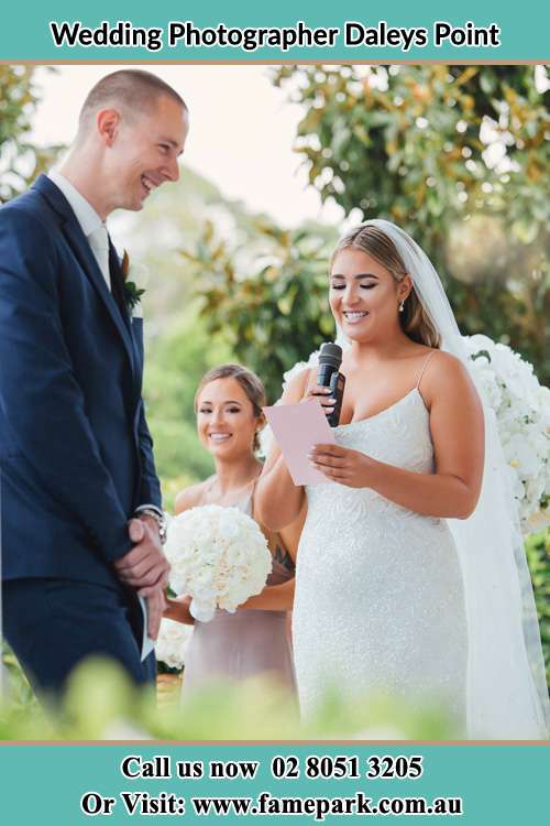 The Bride reading a note as the Groom happily listens Daleys Point