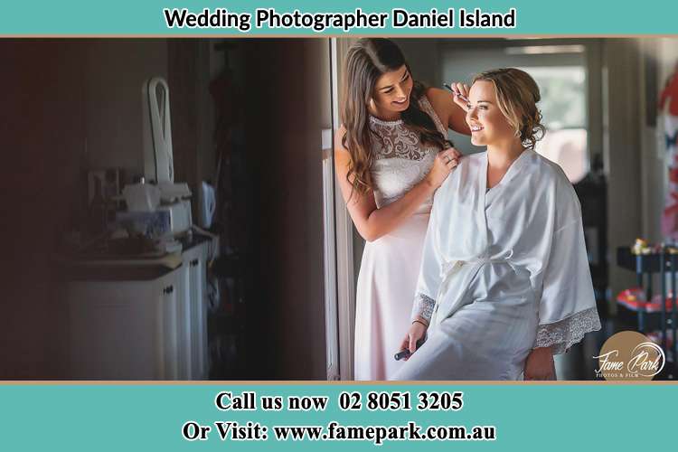 Photo of bridesmaid preparing the Bride for her wedding Daniel Island