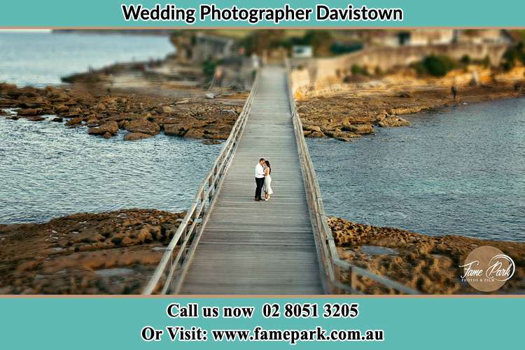 Photo of the groom and the Bride kissing on the bride Davistown