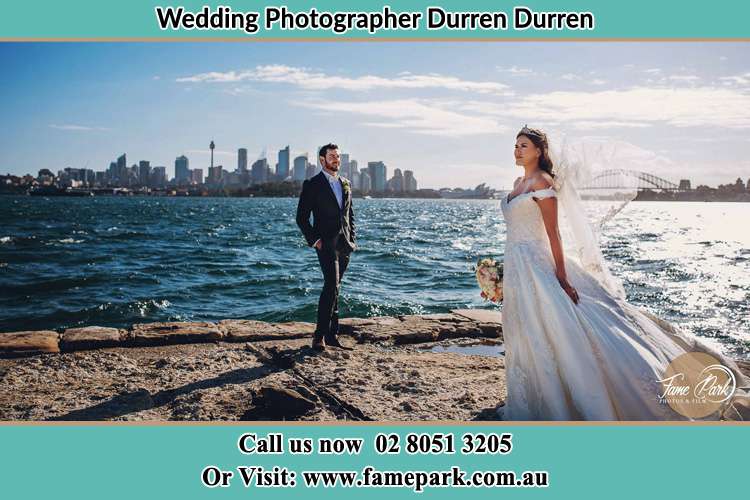 The Groom and the Bride poses for the camera near the shore Durren Durren