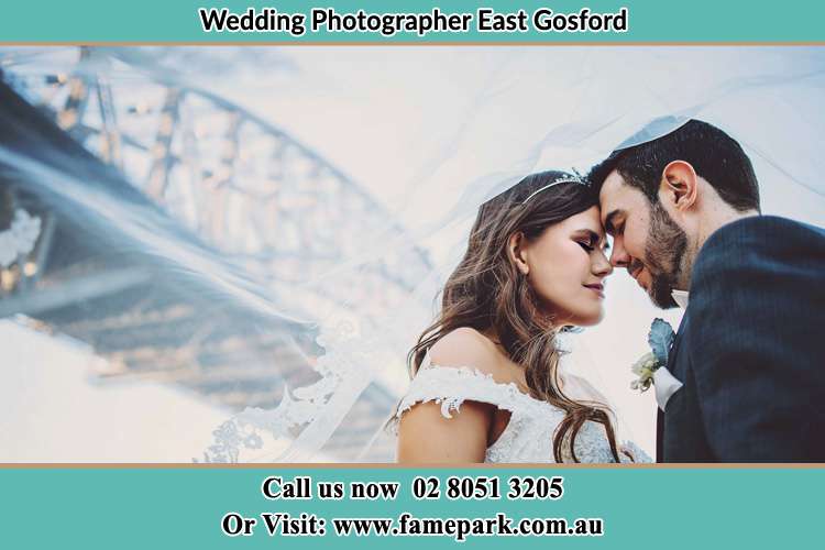 The Groom and the Bride close together under the bridge East Gosford