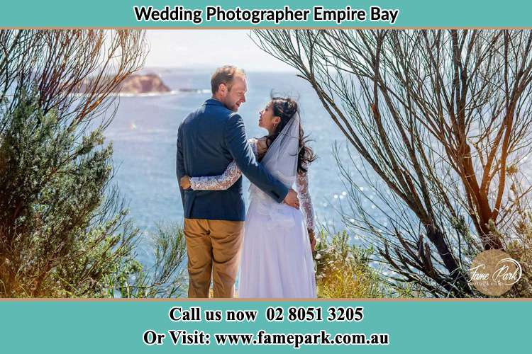 Photo of the Groom and the Bride looking each other near the sea front Empire Bay NSW 2257