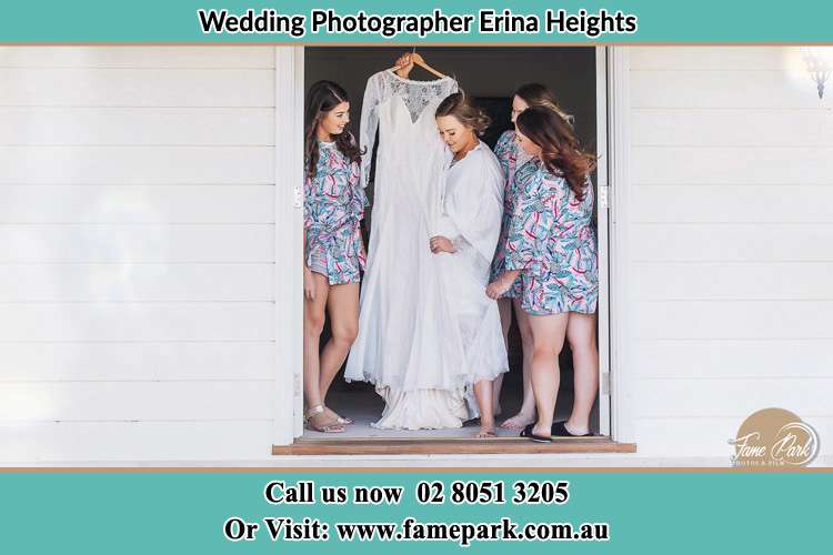 Photo of the Bride and the bridesmaids checking the wedding gown at the door Erina Heights NSW 2260