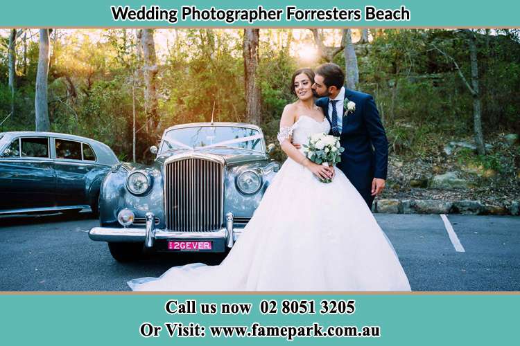 Photo of the Bride and Groom besides the bridal car Forresters Beach