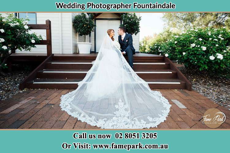 Photo of the Bride and Groom sitting in the stairs Fountaindale