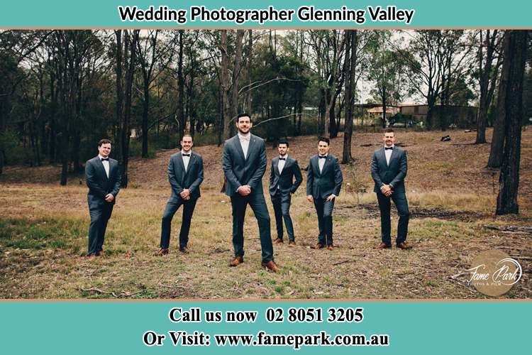 The Groom with his groomsmen pose in front of the camera Glenning Valley