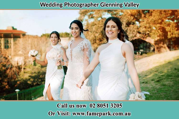 The Bride and her bridesmaids smiles as they walk Glenning Valley