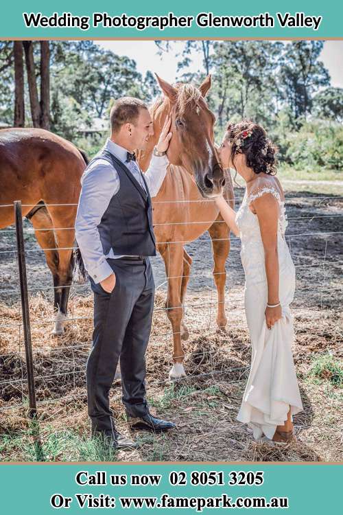 Photo of the Groom and the Bride caressing a horse Glenworth Valley NSW 2250