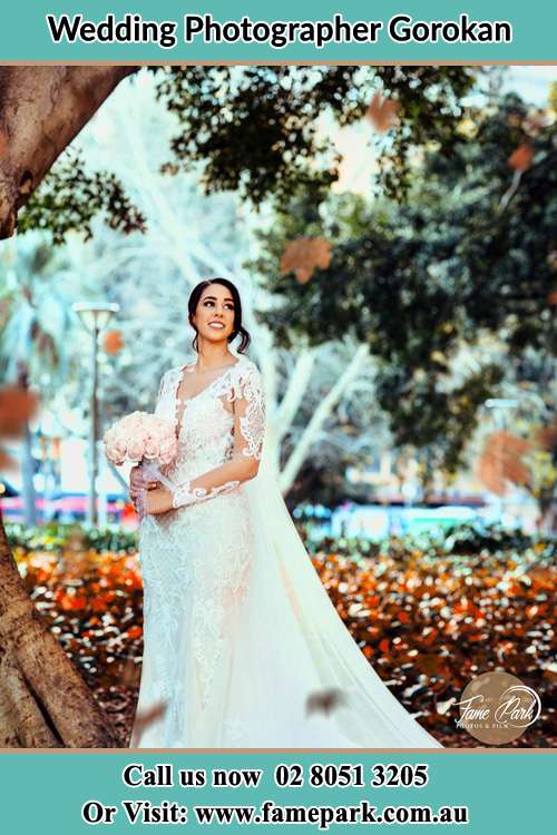 Bride holding bouquet of flowers under the tree Gorokan