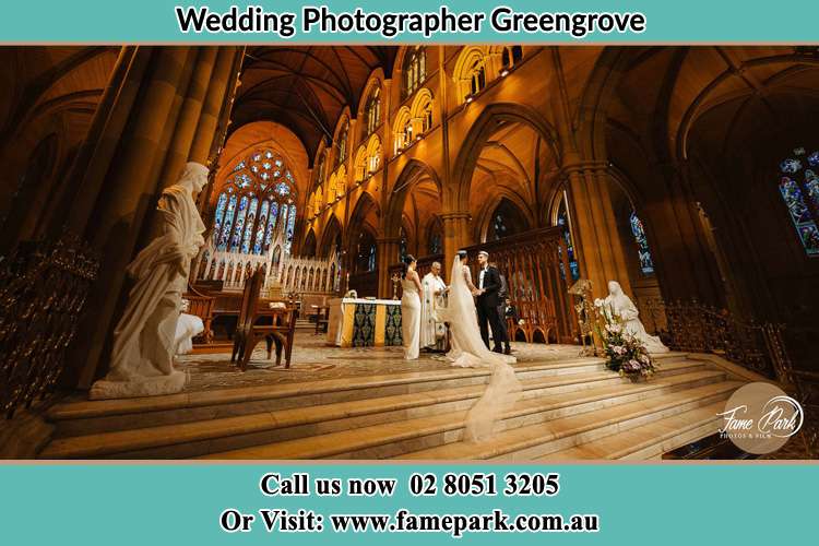 Bride and Groom at the Altar with the Priest Greengrove