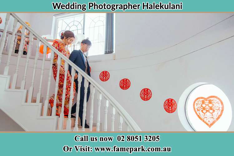 Photo of the Bride and the Groom walking down the stairs Halekulani