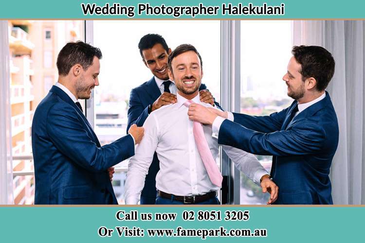 Photo of the Groom helping by the groomsmen getting ready Halekulani NSW 2262