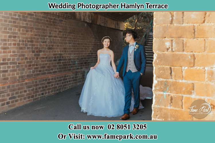 Photo of the Groom and the Bride walks while holding their hands Hamlyn Terrace