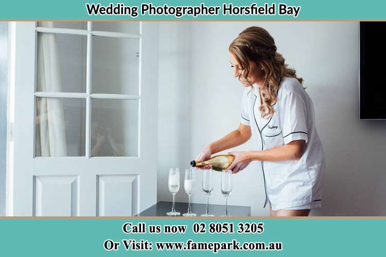 Photo of the Bride pouring wine to the glasses Horsfield Bay NSW 2256