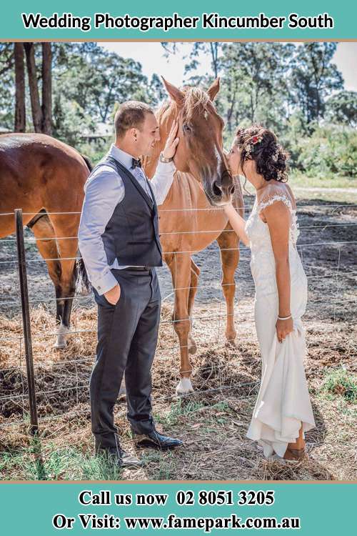 Photo of the Groom and the Bride caressing a horse Kincumber South NSW 2251