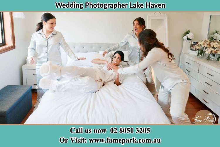 Photo of the Bride and the bridesmaids playing on bed Lake Haven NSW 2263