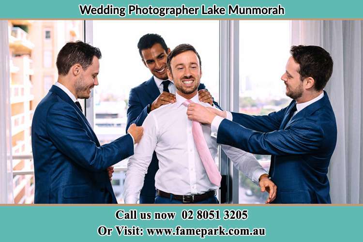 Photo of the Groom helping by the groomsmen getting ready Lake Munmorah NSW 2259