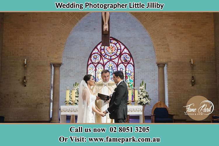 Photo of the Bride and the Groom with the Priest at the altar Little Jilliby NSW 2259