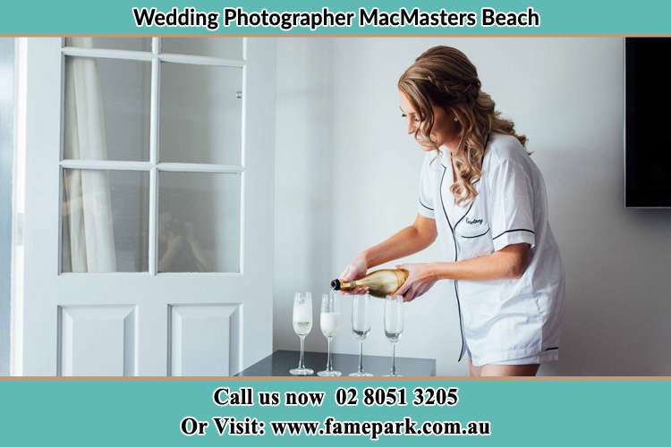 Photo of the Bride pouring wine on the glasses MacMasters Beach NSW 2251