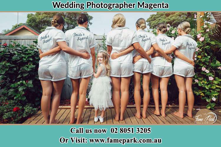 Behind photo of the Bride and the bridesmaids with the flower girl looking back Magenta NSW 2261