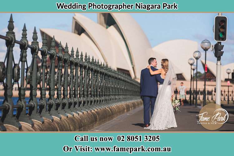 The Groom and the Bride walking towards the Sydney Grand Opera House Niagara Park NSW 2250