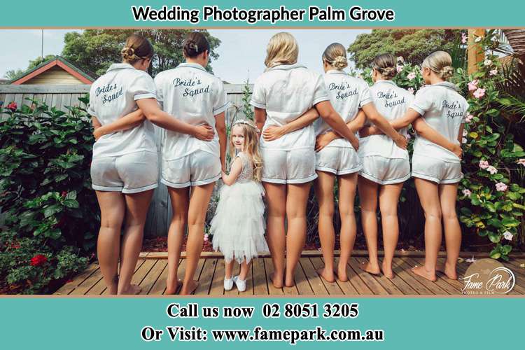 Behind photo of the Bride and the bridesmaids with the flower girl looking back Palm Grove NSW 2258