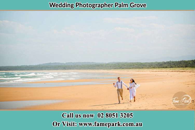 Photo of the Groom and the Bride walking at the sea shore Palm Grove NSW 2258