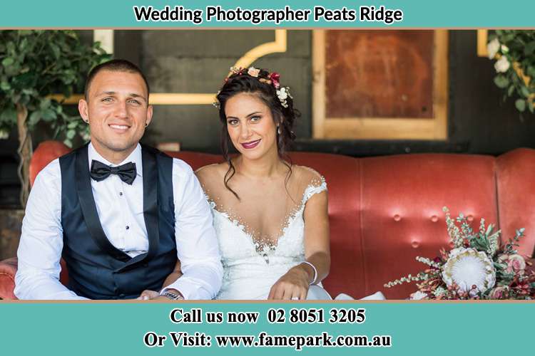 The Groom and the Bride sitting and smiling on the camera Peats Ridge NSW 2250